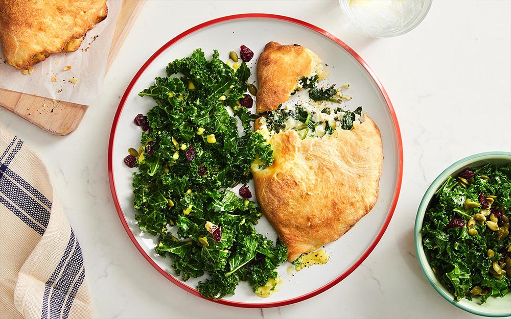 Ricotta Stuffed Calzones with mozzarella cheese & kale salad,