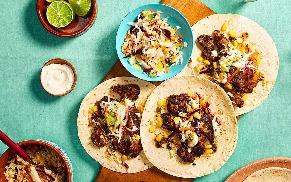 Spicy Jerk Chicken Tacos with a sweet corn and lime slaw,