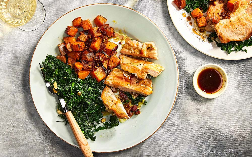 Maple Cider Pork Chops with garlic kale and pecan sweet potatoes,