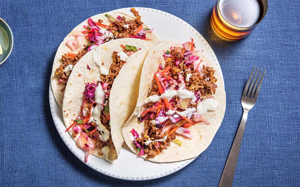 Quick Beef Tacos with lime slaw and sour cream,