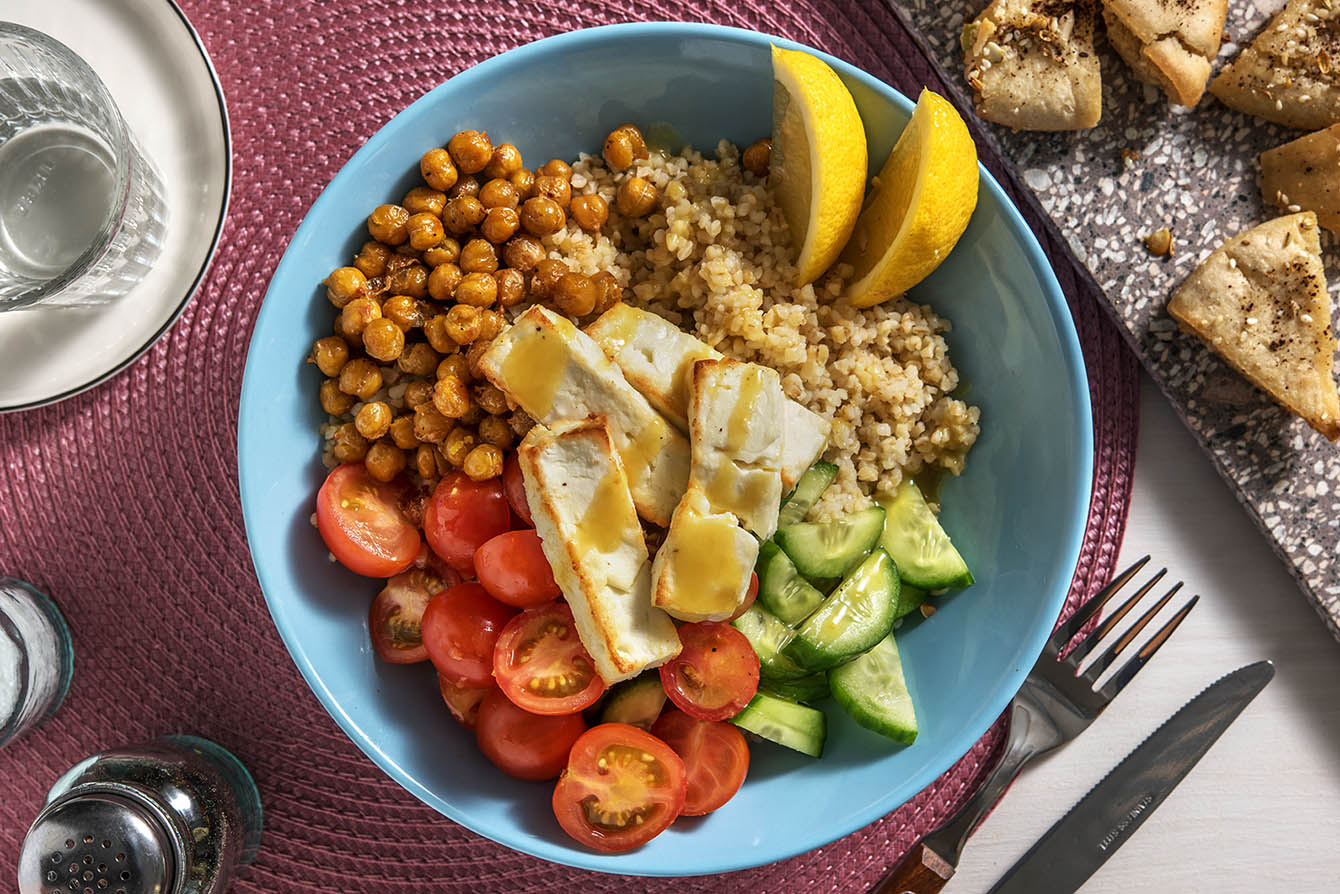 Mediterranean Baked Feta with spiced pita chips and a lemon-caper dressing