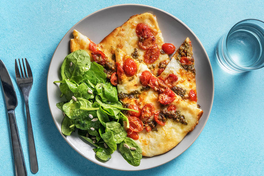 Pesto Mozzarella Pizza with grape tomatoes and Parmesan