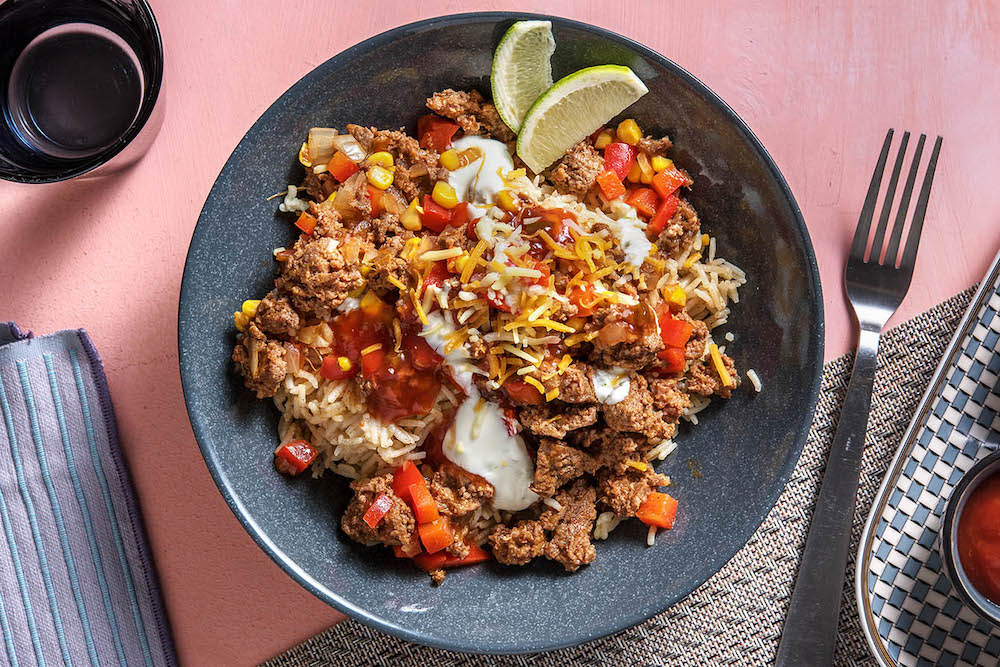 Mexican Beef Burrito Bowls with cheese, sour cream and salsa