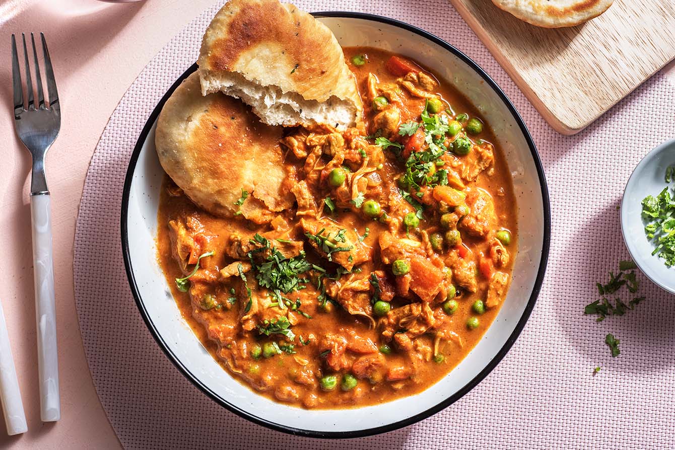 Slow-Cooker Chicken Tikka Masala with cilantro and garlic naan