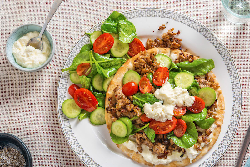 Pork Gyro Pitas with feta cream sauce and spinach salad